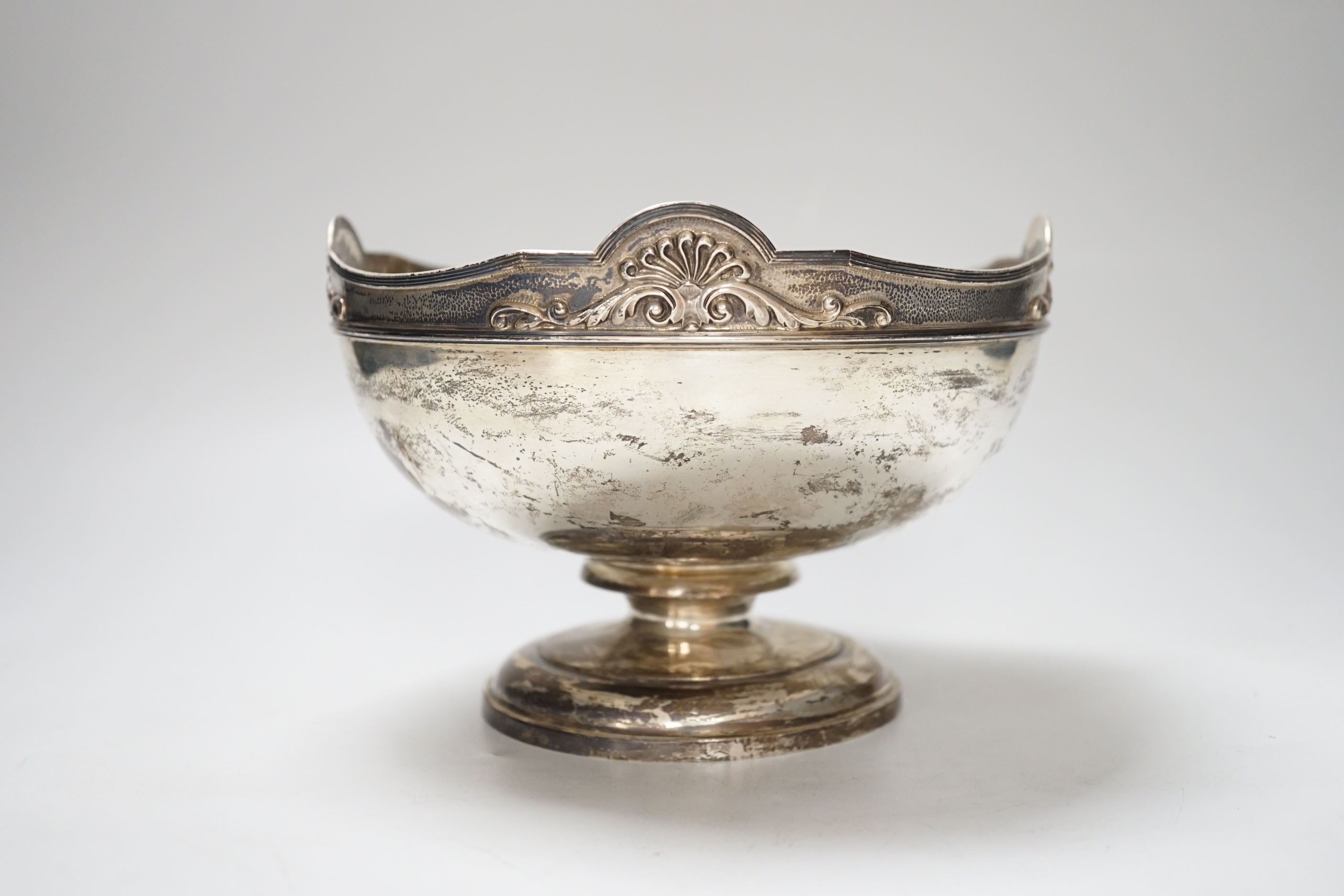 A George V silver rose bowl, with anthemion and scroll decorated rim, and 1918 presentation inscription, makers Garrard & Co., London 1913, diameter 18.5cm, 601 grams